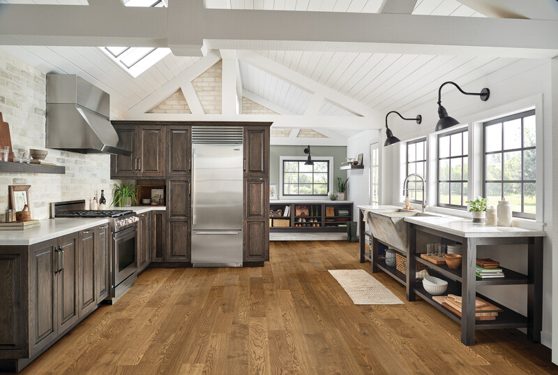 Kitchen with hardwood floors and picture windows on one side 